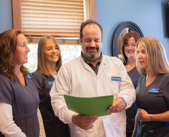 Northern Family Dental Team Looking at patient file Northern Family Dental Team Looking at patient file